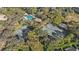 Aerial view showcasing the tennis courts and community pool surrounded by mature trees at 3352 Park Grove Ct, Longwood, FL 32779