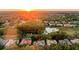 An aerial perspective shows a sunset neighborhood with a pond, golf course, and well-maintained homes at 3352 Park Grove Ct, Longwood, FL 32779
