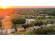 An aerial perspective shows a sunset neighborhood with a pond, golf course, and well-maintained homes at 3352 Park Grove Ct, Longwood, FL 32779