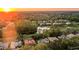 An aerial perspective shows a sunset neighborhood with a pond, golf course, and well-maintained homes at 3352 Park Grove Ct, Longwood, FL 32779