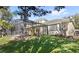Expansive backyard featuring a screened-in pool and lush landscaping, perfect for outdoor activities and relaxation at 3352 Park Grove Ct, Longwood, FL 32779