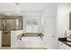 Luxurious primary bathroom with a glass shower, soaker tub, and vanity with granite countertop at 3352 Park Grove Ct, Longwood, FL 32779