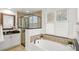 Beautiful bathroom featuring a soaking tub, glass shower, and modern vanity with granite countertops at 3352 Park Grove Ct, Longwood, FL 32779