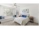 Bright bedroom with a tufted headboard, a window seat, and ample natural light from two windows at 3352 Park Grove Ct, Longwood, FL 32779