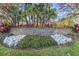 Community sign reading 'Alaqua Lakes' with lovely landscaping at 3352 Park Grove Ct, Longwood, FL 32779
