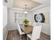 Bright dining room with modern chandelier and a beautiful table set for six at 3352 Park Grove Ct, Longwood, FL 32779