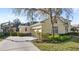 Side view of house featuring a basketball hoop, well-kept yard, and three-car garage at 3352 Park Grove Ct, Longwood, FL 32779