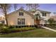 Front view of the house featuring a lush front lawn and beautiful landscaping at 3352 Park Grove Ct, Longwood, FL 32779