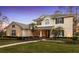 Two-story home with manicured lawn and a grand entryway at dusk at 3352 Park Grove Ct, Longwood, FL 32779