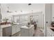 Bright open kitchen showcasing an island with bar seating, stainless steel appliances, and luxury vinyl floors at 3352 Park Grove Ct, Longwood, FL 32779