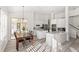 Bright kitchen with stainless steel appliances, white cabinets, and a dining area with a view of the patio at 3352 Park Grove Ct, Longwood, FL 32779