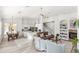 Open concept living room featuring a cozy fireplace, staircase, ceiling fan, and dining area with luxury vinyl floors at 3352 Park Grove Ct, Longwood, FL 32779