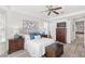 Comfortable main bedroom with luxury vinyl floors and neutral decor with access to the ensuite bathroom at 3352 Park Grove Ct, Longwood, FL 32779