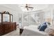 Bright primary bedroom with tray ceiling, large windows with shutters, and luxury vinyl floors at 3352 Park Grove Ct, Longwood, FL 32779