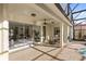Outdoor patio with sliding glass doors and a ceiling fan, perfect for dining and relaxation at 3352 Park Grove Ct, Longwood, FL 32779