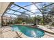 Screened-in pool and spa with sun loungers in a lush backyard, great for relaxation and entertainment at 3352 Park Grove Ct, Longwood, FL 32779
