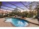 Inviting screened-in pool and spa with a waterfall feature, set against a beautiful sunset backdrop at 3352 Park Grove Ct, Longwood, FL 32779