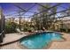 Relaxing screened-in pool and spa with elegant lounge chairs and mature trees, enhanced by a vibrant sunset at 3352 Park Grove Ct, Longwood, FL 32779