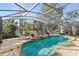 Private screened-in pool and spa area with comfortable seating, nestled in a tranquil, landscaped backyard at 3352 Park Grove Ct, Longwood, FL 32779