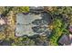 Aerial view of tennis courts with a seating area, nestled within a lush community at 3352 Park Grove Ct, Longwood, FL 32779