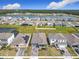 An aerial view of a residential community with a lake and well-maintained lawns and a house with solar panels at 338 Crestwind Dr, Daytona Beach, FL 32124