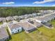 Aerial view of homes and neighborhood, showcasing well-manicured lawns, pools, and an overview of neighborhood's layout at 338 Crestwind Dr, Daytona Beach, FL 32124