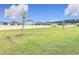 Vast, open backyard with a healthy, green lawn and perimeter fence with other residential housing for the neighborhood at 338 Crestwind Dr, Daytona Beach, FL 32124