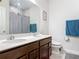 Bright bathroom showcasing a double sink vanity with dark wood cabinets, a large mirror, and modern fixtures at 338 Crestwind Dr, Daytona Beach, FL 32124