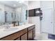 Modern bathroom with double vanity, sleek countertops, stylish fixtures, glass enclosed shower and a wall-mounted TV at 338 Crestwind Dr, Daytona Beach, FL 32124