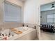Inviting bathroom showcasing a soaking tub with tiled accents, creating a spa-like retreat, leading to the bedroom at 338 Crestwind Dr, Daytona Beach, FL 32124