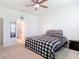 Bright bedroom with ceiling fan, adjacent bathroom, and a comfortable bed featuring stylish bedding at 338 Crestwind Dr, Daytona Beach, FL 32124
