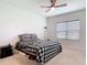 Cozy bedroom with ceiling fan, natural light from the window, and a comfortable bed featuring stylish bedding at 338 Crestwind Dr, Daytona Beach, FL 32124