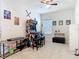 Neutral-toned bedroom with carpet, ceiling fan, and an arcade game for gaming enthusiasts at 338 Crestwind Dr, Daytona Beach, FL 32124