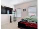 Cozy bedroom featuring a large TV, light walls, and two windows allowing for natural light to illuminate the space at 338 Crestwind Dr, Daytona Beach, FL 32124