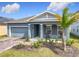 Charming single-Gathering home with a well-manicured front yard and a welcoming front porch with chairs at 338 Crestwind Dr, Daytona Beach, FL 32124