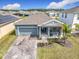 Beautiful single-story home featuring a manicured lawn and a charming covered front porch, perfect for relaxing at 338 Crestwind Dr, Daytona Beach, FL 32124