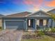 Charming single-Gathering home with a well-manicured front yard and a welcoming front porch with chairs at 338 Crestwind Dr, Daytona Beach, FL 32124