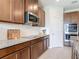 Modern kitchen featuring granite countertops, stainless steel microwave, and sleek backsplash at 338 Crestwind Dr, Daytona Beach, FL 32124
