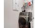 Modern laundry room equipped with high-efficiency washer and dryer, plus organized storage solutions at 338 Crestwind Dr, Daytona Beach, FL 32124