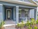 Inviting front porch with seating, neutral columns, and manicured landscaping, perfect for relaxing outdoors at 338 Crestwind Dr, Daytona Beach, FL 32124