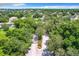 Aerial view of the gated entrance of the community surrounded by beautiful mature trees and greenery at 3415 Starbird Dr, Ocoee, FL 34761