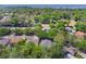 Aerial view highlighting mature trees, lush landscaping, and waterfront views at 3415 Starbird Dr, Ocoee, FL 34761