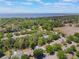 Aerial view of the community, showcasing mature trees, lush landscaping, and views of the water at 3415 Starbird Dr, Ocoee, FL 34761