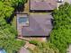 Aerial view showcasing a screened in pool and patio and a newer roof, with mature landscaping at 3415 Starbird Dr, Ocoee, FL 34761