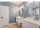Stylish bathroom featuring dual vessel sinks on elegant vanities, decorative mirrors, and modern lighting at 3415 Starbird Dr, Ocoee, FL 34761
