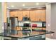 Kitchen with stainless appliances, black countertops, and ample wood cabinets at 3415 Starbird Dr, Ocoee, FL 34761