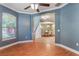 Open-concept living room boasts tons of light, wood flooring, and flows into the dining room at 3415 Starbird Dr, Ocoee, FL 34761