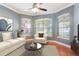 Cozy living room featuring bright windows, hardwood floors, and a classic modern design at 3415 Starbird Dr, Ocoee, FL 34761
