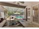 Covered patio featuring a pool view, comfortable seating, and a tranquil atmosphere at 3415 Starbird Dr, Ocoee, FL 34761