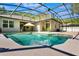 An inviting pool with water feature set into a screened enclosure with backyard views at 3415 Starbird Dr, Ocoee, FL 34761